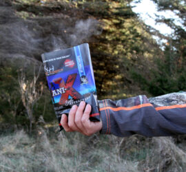 Man holding a bag of Ani-X Scent Attractant