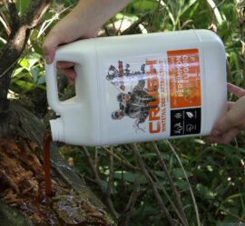 CRUSH Persimmon Liquid being poured onto a log