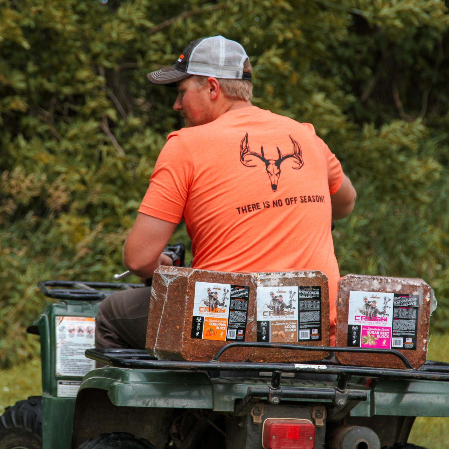 Man on a 4-wheeler with 3 CRUSH protein blocks on the back