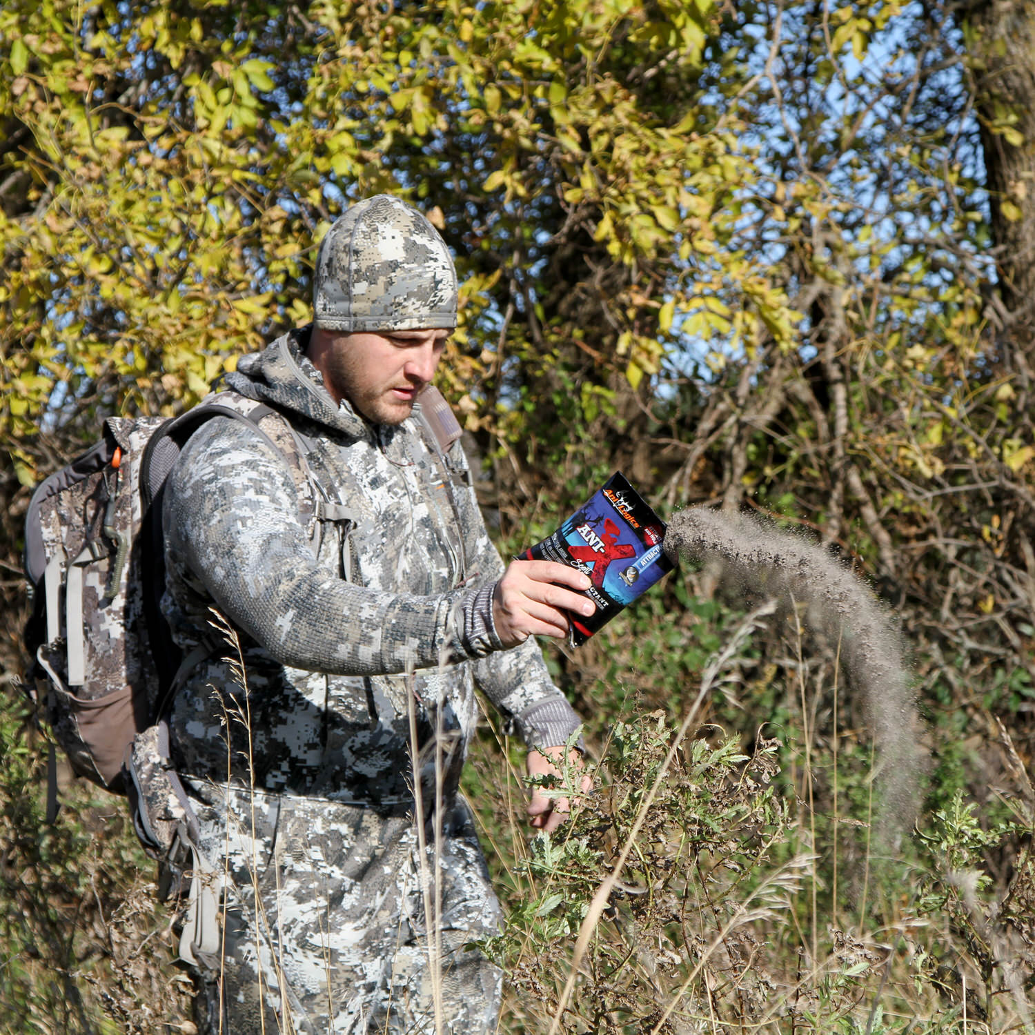 Man spreading out a bag of Ani-X Scent Attractant