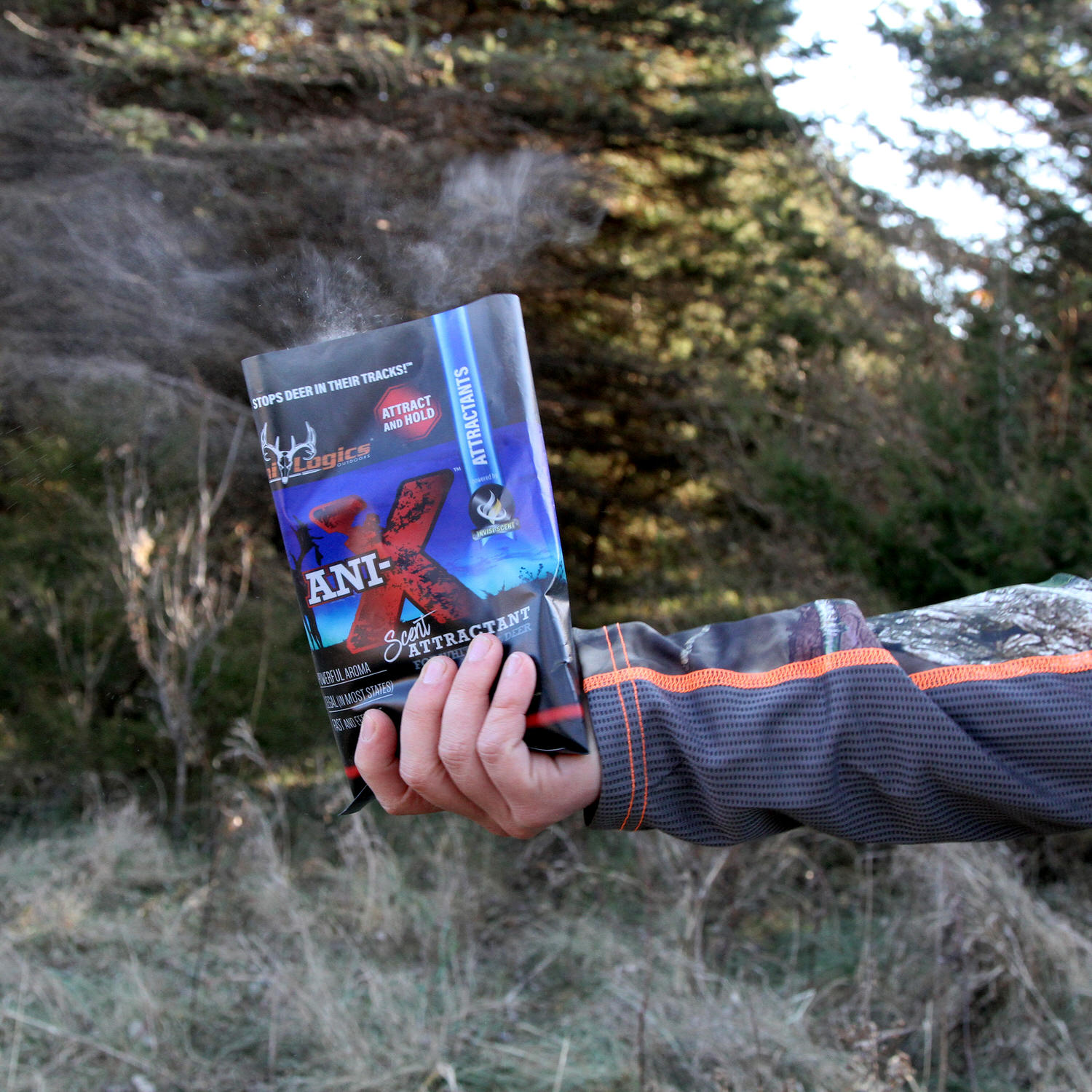 Man holding a bag of Ani-X Scent Attractant