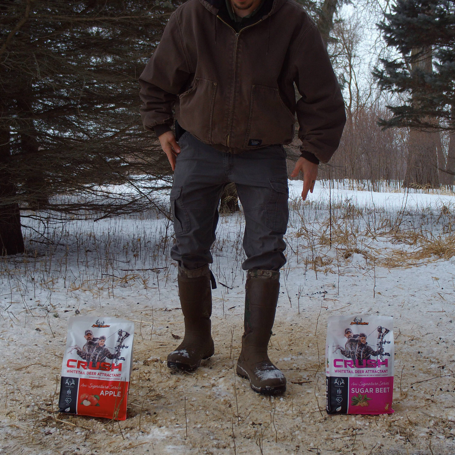 Man between two bags of CRUSH granular attractant