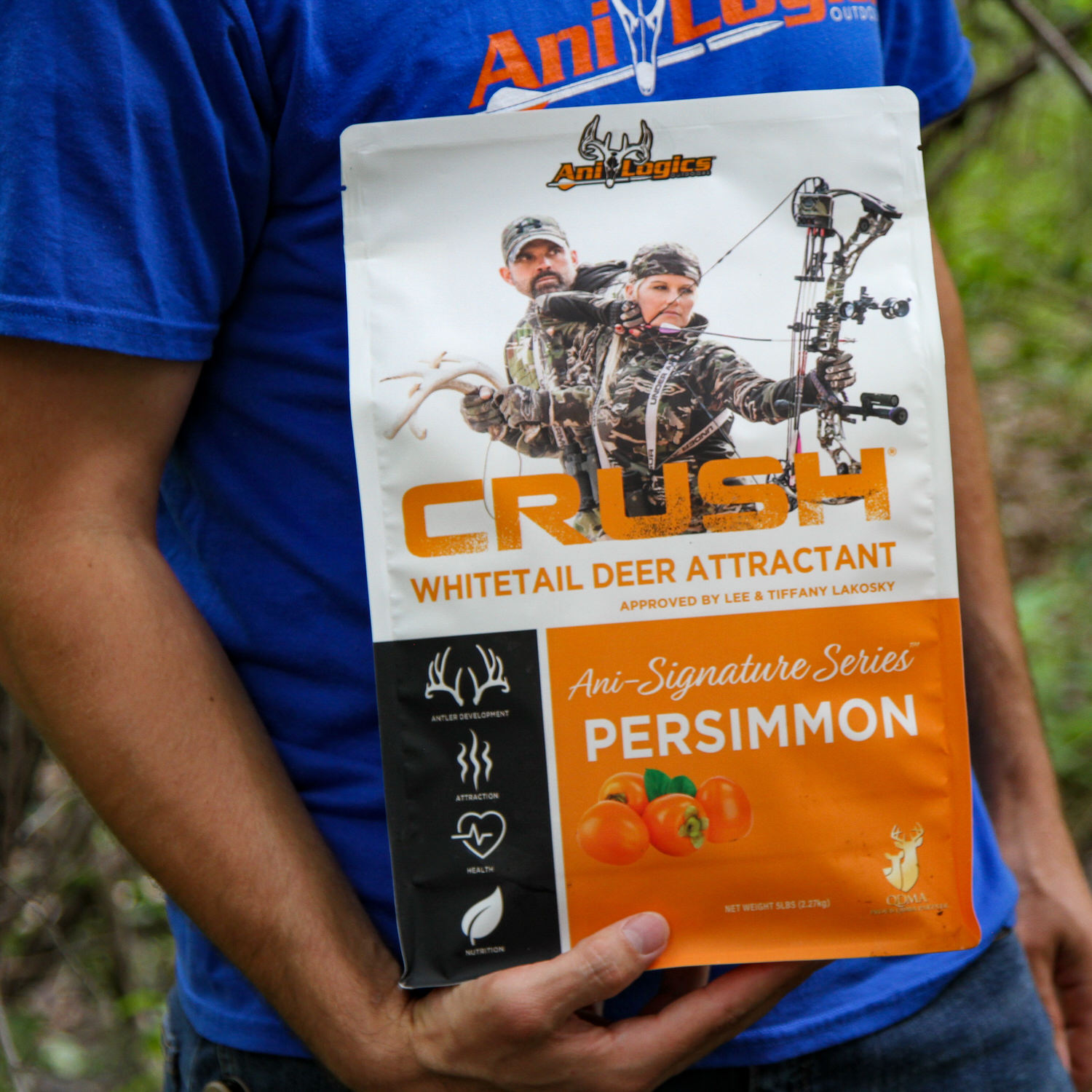 Man holding a bag of CRUSH Persimmon Granular Attractant