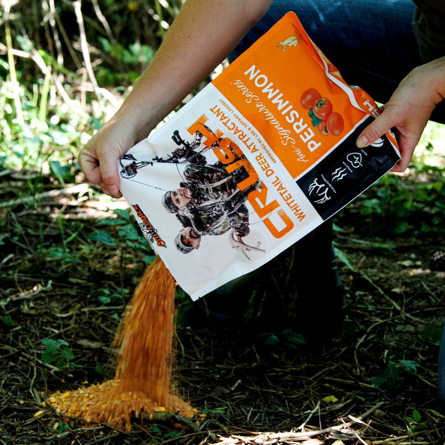 Man pouring out a bag of CRUSH Persimmon Granular Attractant onto the ground