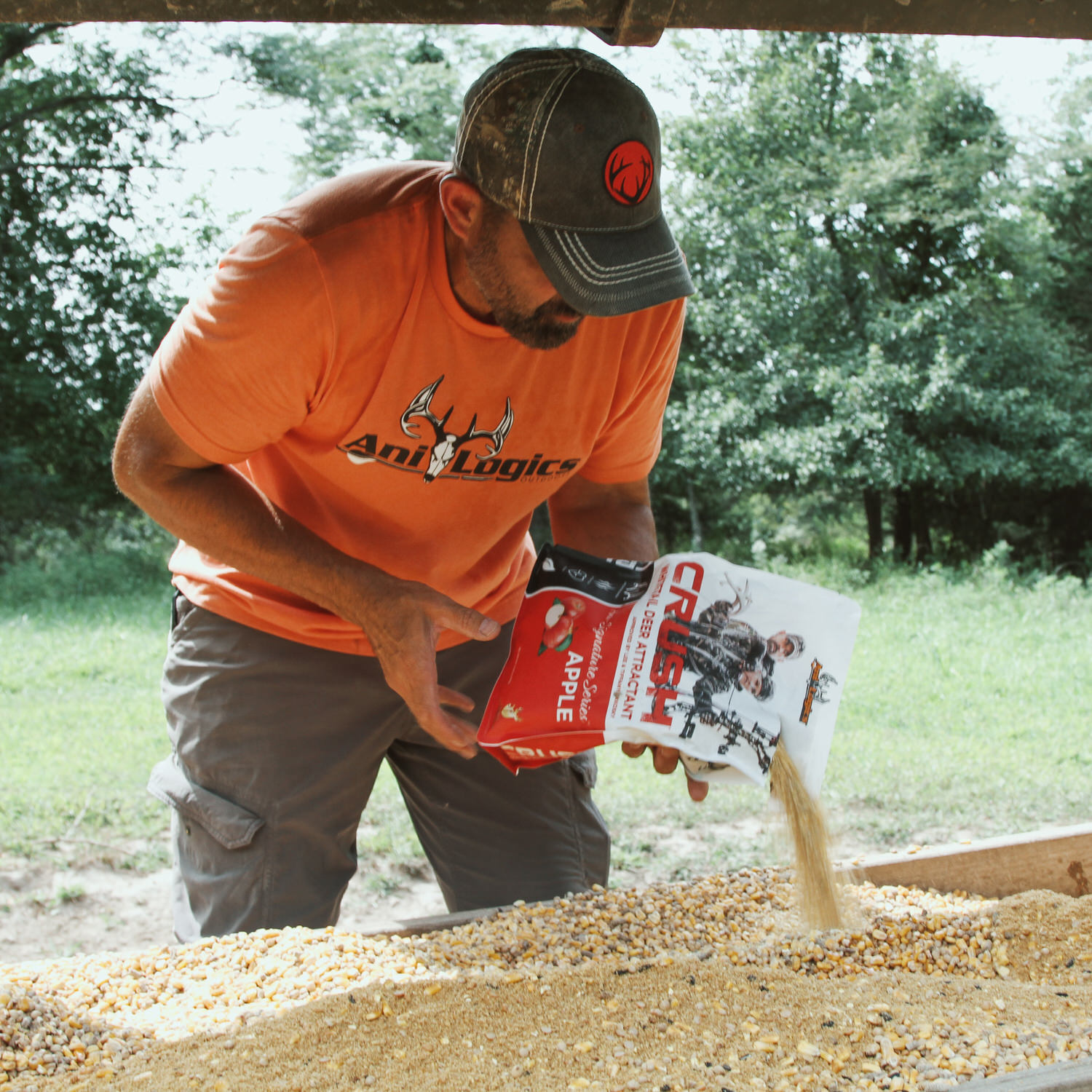 Lee Lakosky pouring a bag of CRUSH Apple Granular into a trough