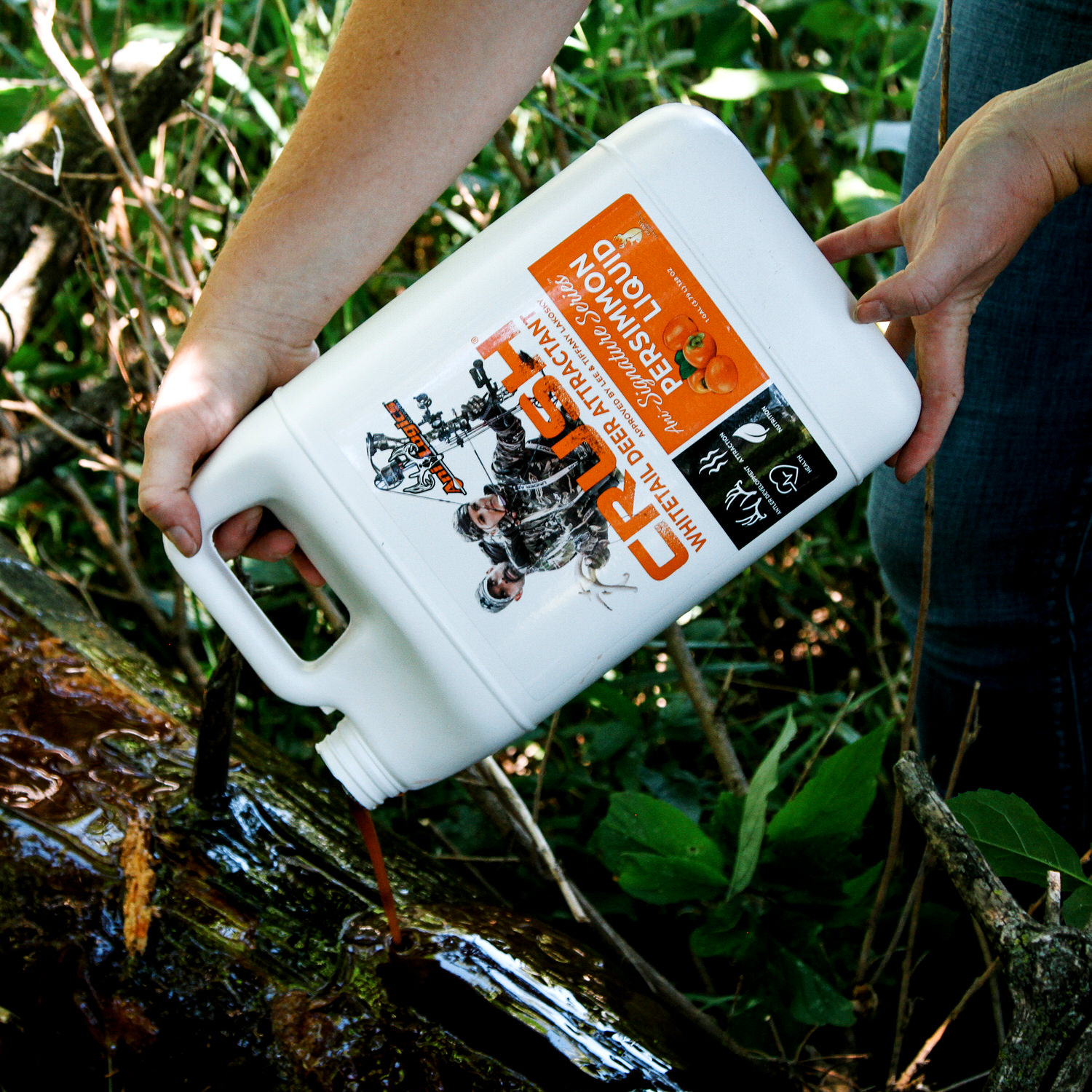 CRUSH Persimmon Liquid being poured onto a rotted log