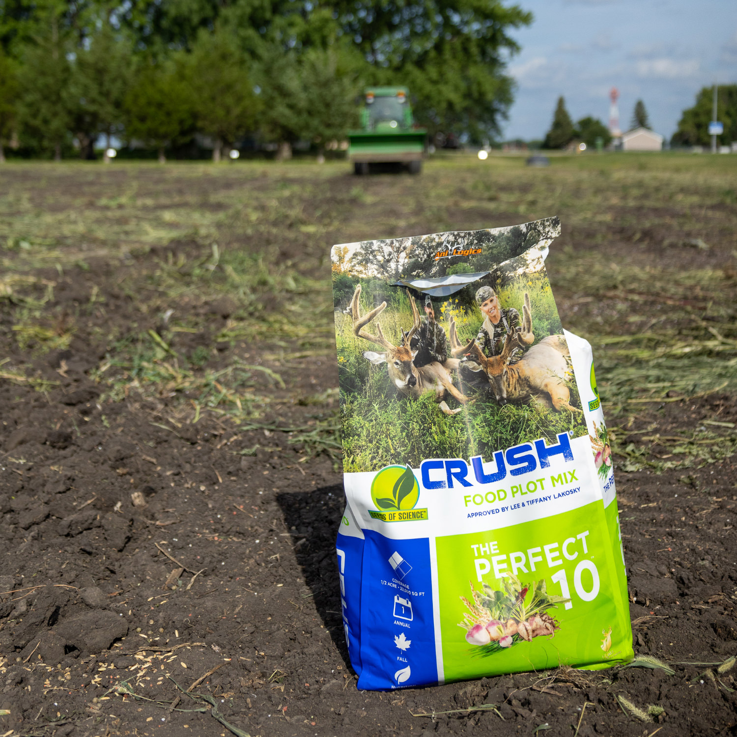 A bag of CRUSH - The Perfect 10 seen on a food plot being prepped by a tractor