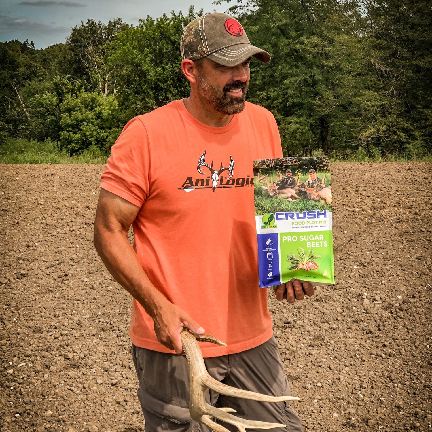 Lee Lakosky holding an antler shed and a bag of CRUSH Pro Sugar Beets