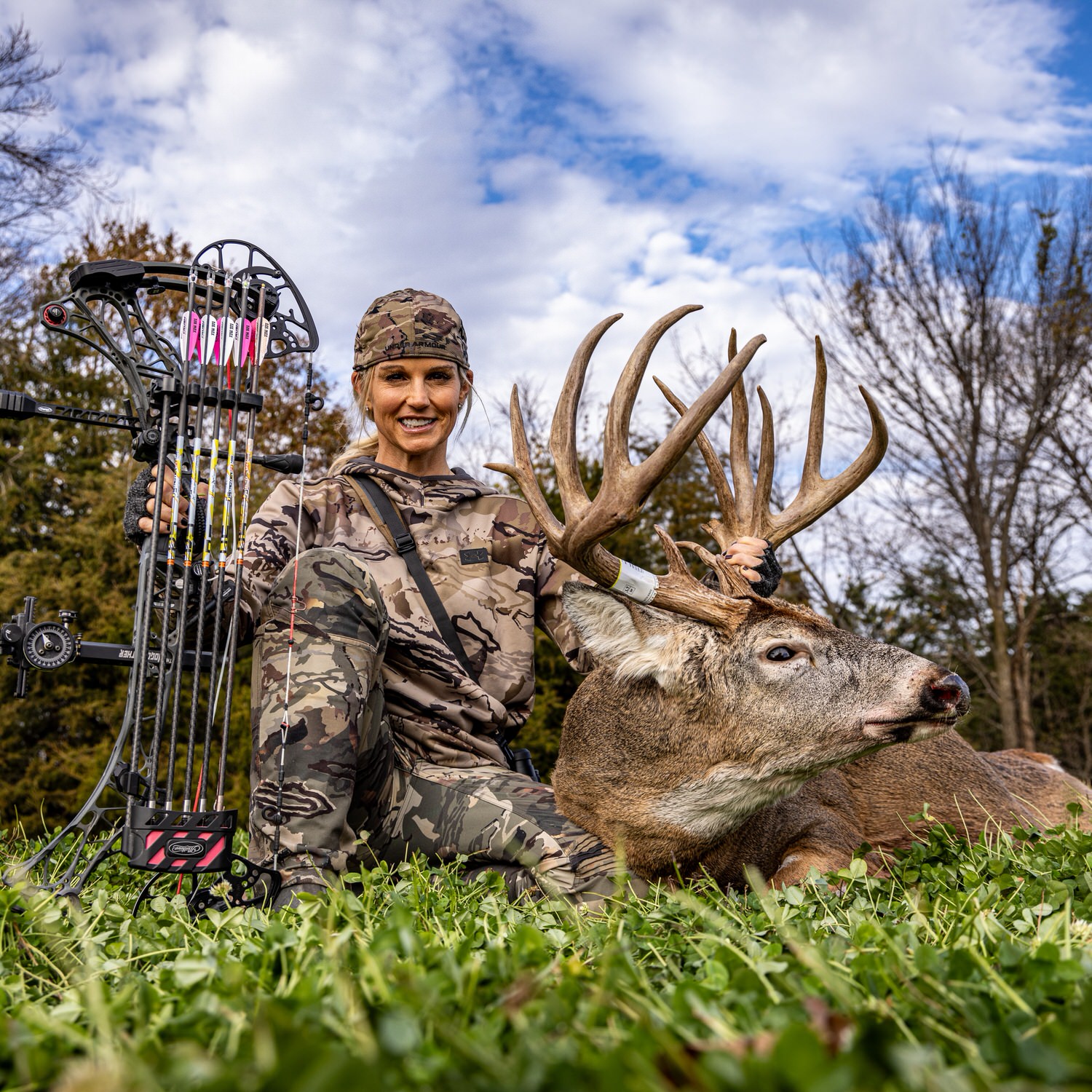 Tiffany Lakosky poses with big buck in a CRUSH Clover Plus Alfalfa food plot