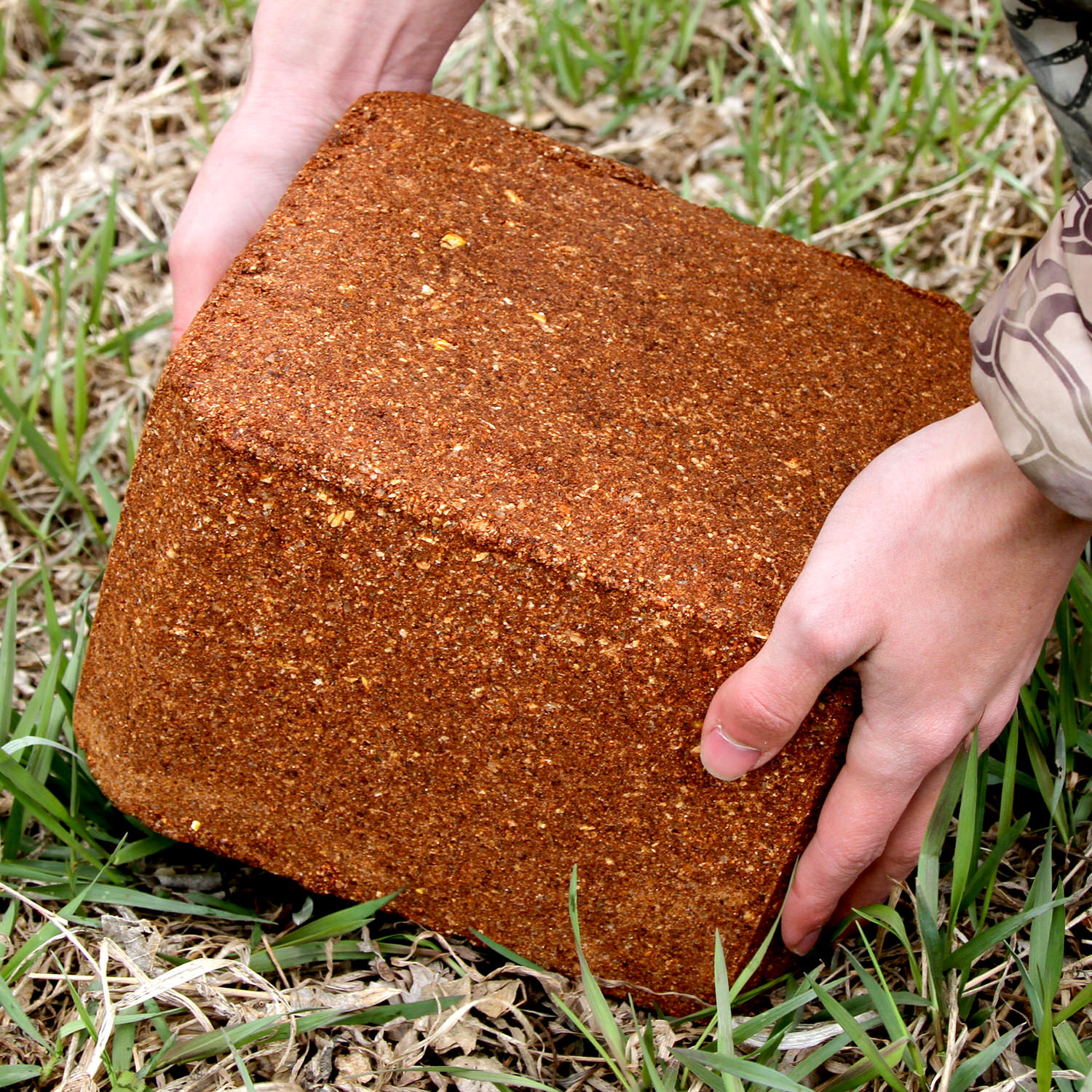 Man placing the CRUSH Apple Block on the ground