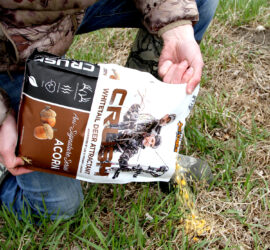 Person pouring a bag of CRUSH Acorn Granular onto the ground