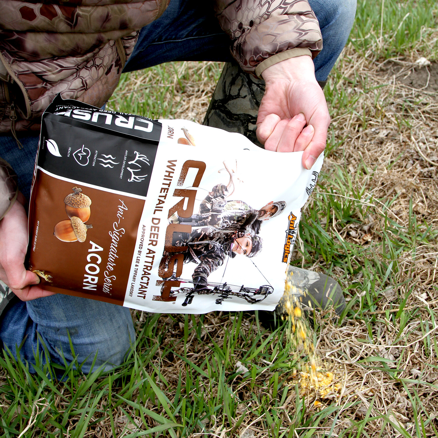 Person pouring a bag of CRUSH Acorn Granular onto the ground