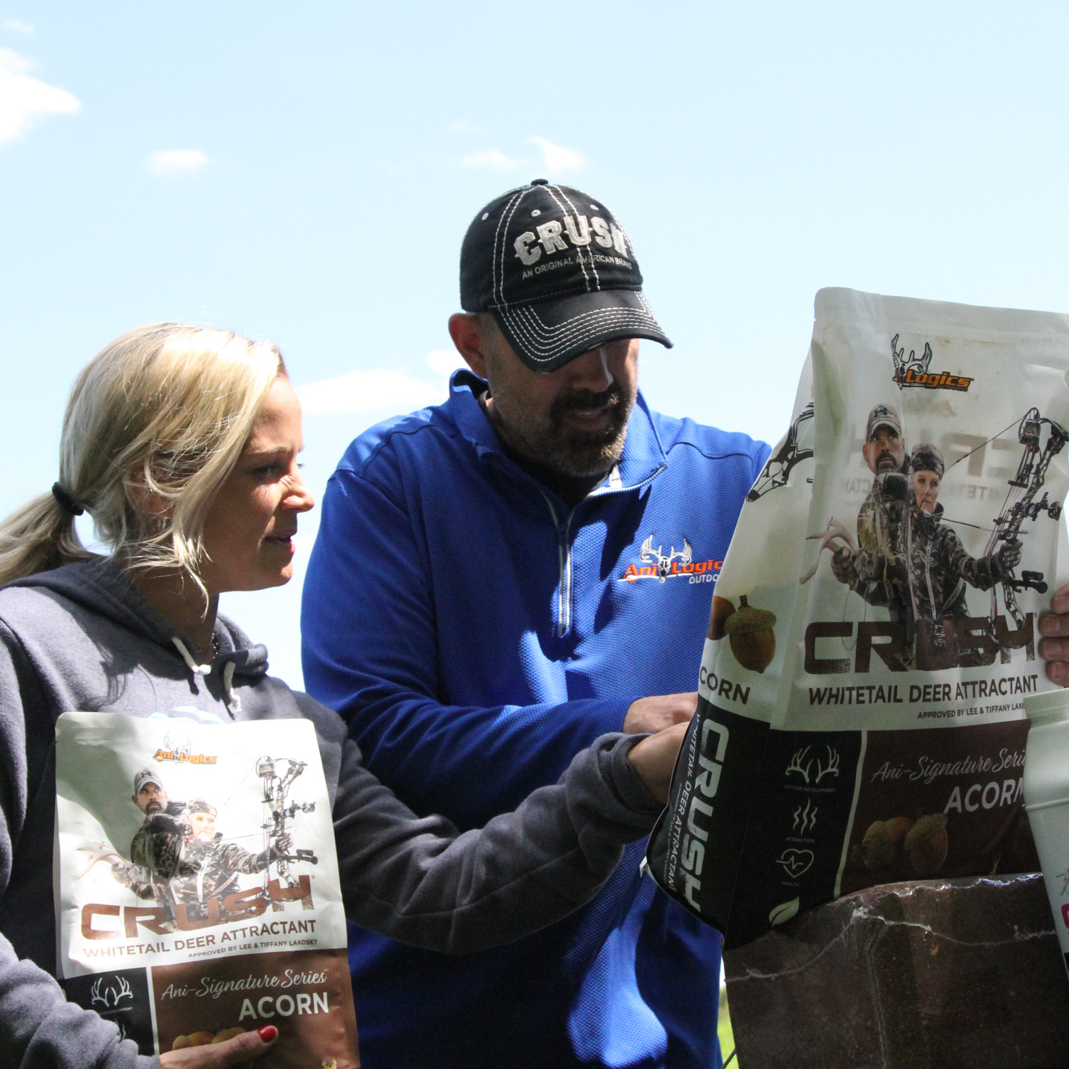 Lee and Tiffany Lakosky looking at the back of a CRUSH Acorn Granular bag