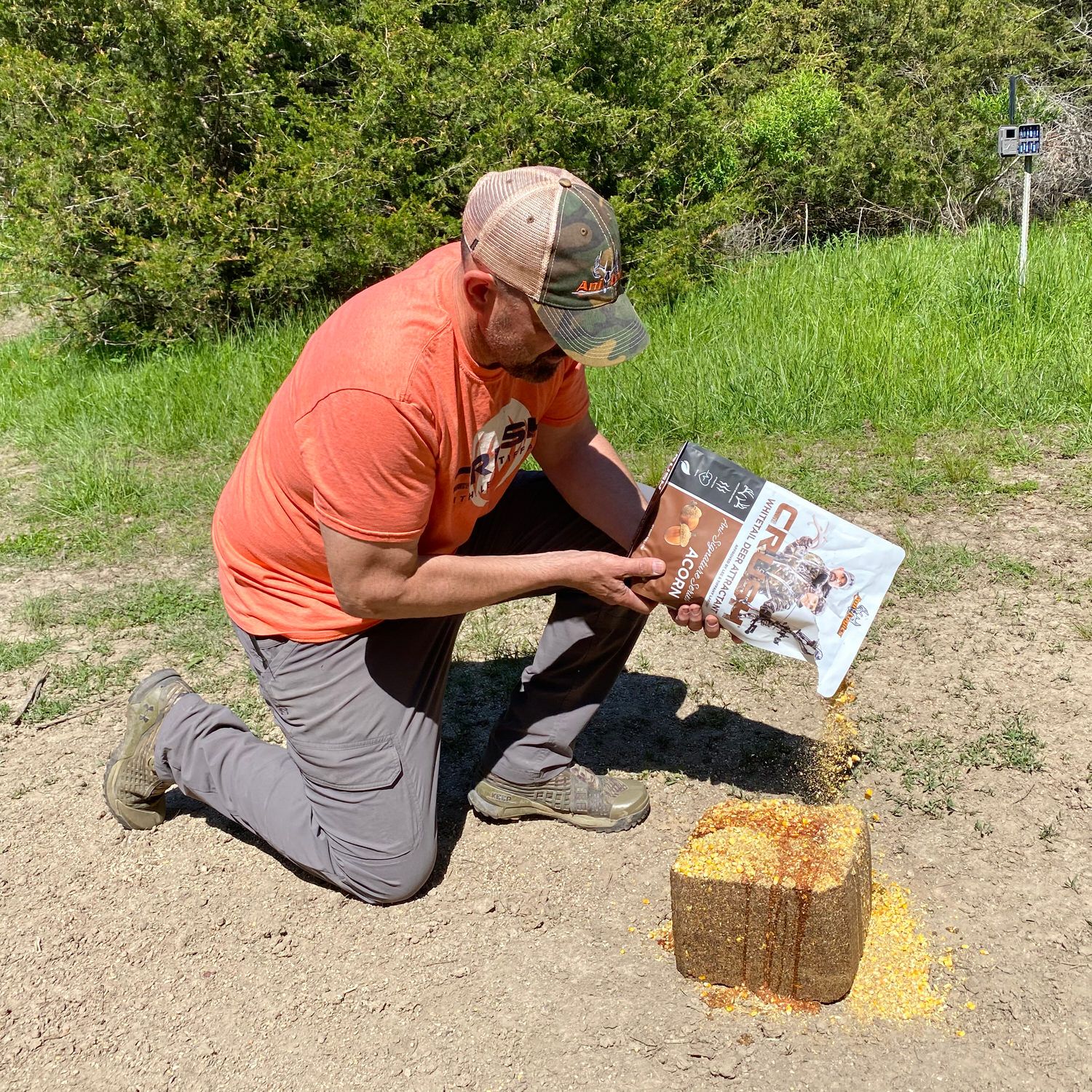 Man pouring a bag of CRUSH Acorn Granular onto a protein block