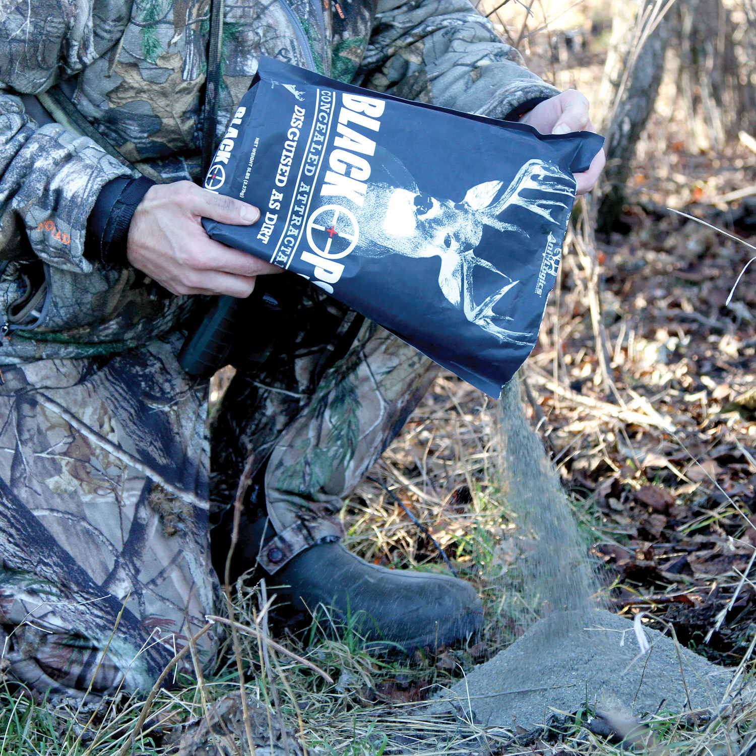 Bag of Black Ops Granular Attractant being poured onto the ground