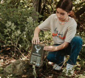 Woman opening a Black Ops Deer Anthem Brick