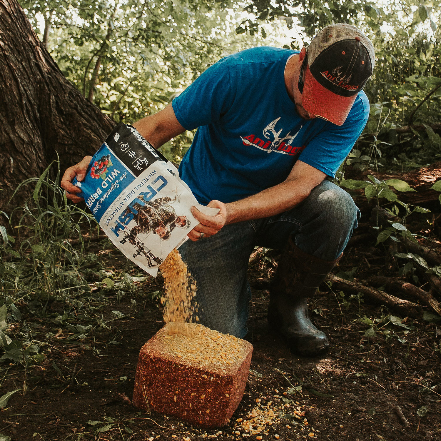 Man pouring CRUSH Wild Barry granular attractant onto a Wild Berry Block