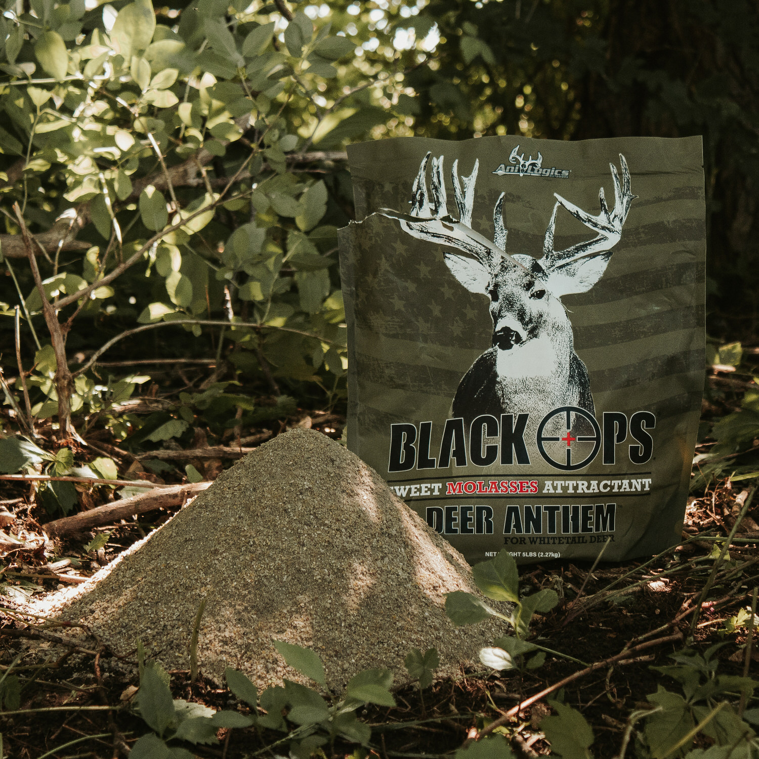 Mound of Black Ops Deer Anthem Molasses Granular Attractant plus the bag