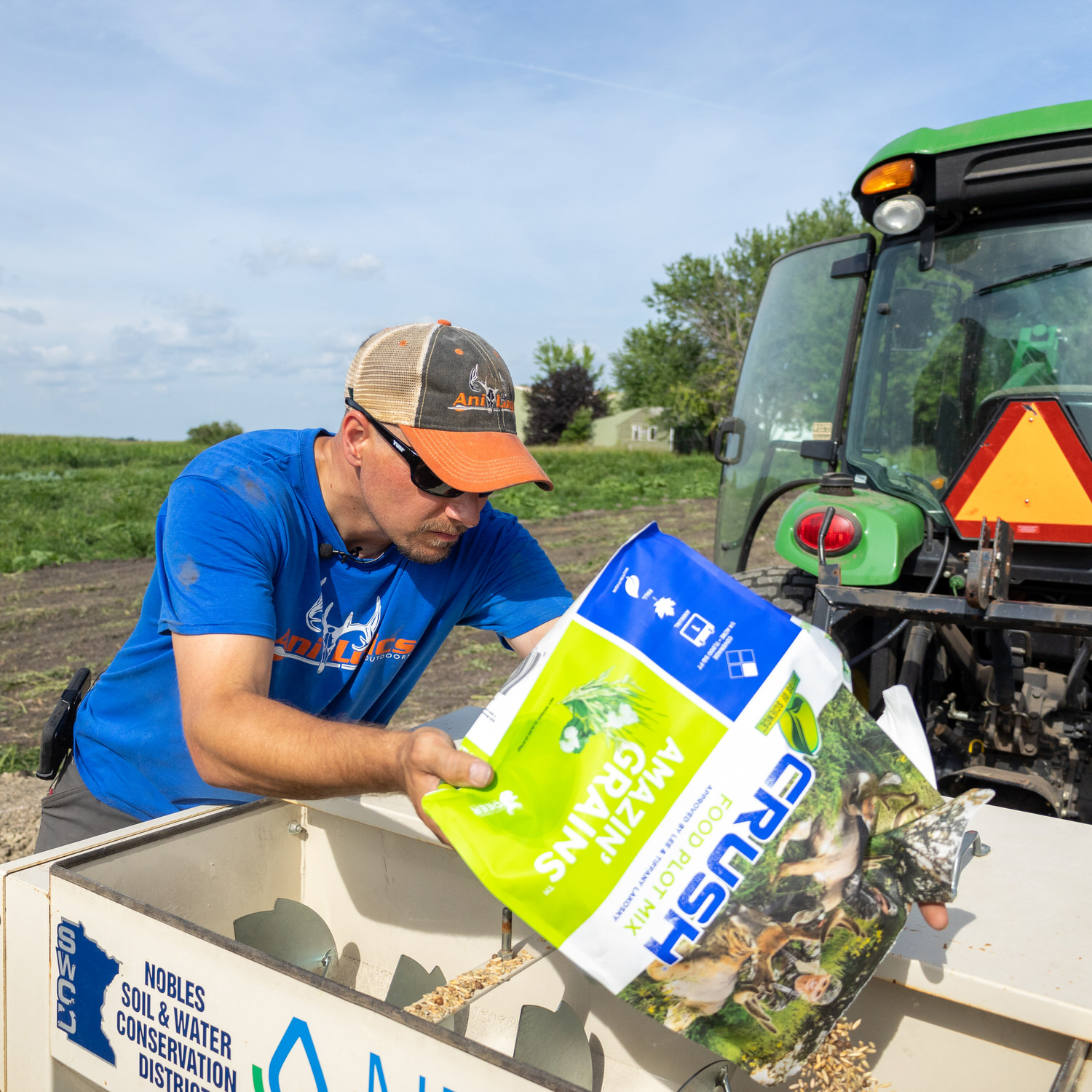 Man pouring a bag of CRUSH Amazin' Grains into spreader