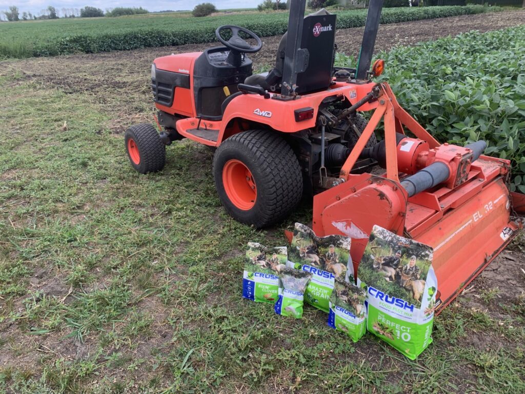 CRUSH Perfect 10 seed blend bags shown next to a tractor with tiller